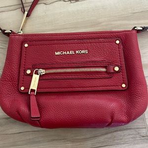 Gently used  crossbody Michael Kors red bag